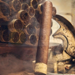 Rocky Patel Cigars The Edge Corojo Toro Single Cigar Leaning Against Bundle of Cigars