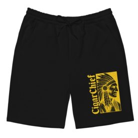Black fleece shorts with a unique yellow printed Cigar Chief logo design on the left leg, displayed flat against a white background