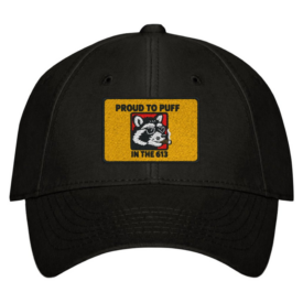 Black baseball cap with a yellow patch featuring a raccoon in sunglasses smoking a cigar, and text that reads 'Proud to Puff in the 613.'