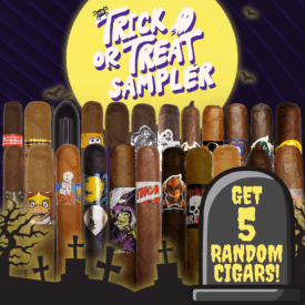 Graphic collage of two rows of cigars set against a large yellow moon and a purple striped sky with flying bats. Graveyard silhouettes fill the foreground. Bold hand lettered text at the top reads Trick or Treat Sampler. A tombstone on the right displays Get 5 Random Cigars. The image evokes Halloween mystery and variety.